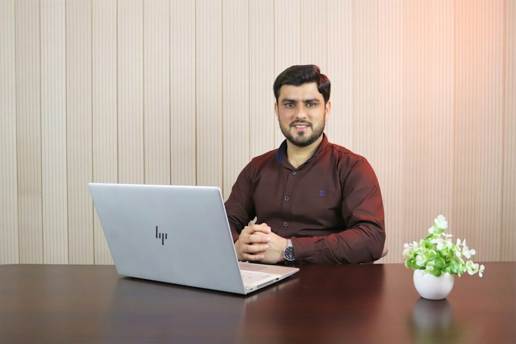 Man building a disciplined wealth plan with notebook and laptop
