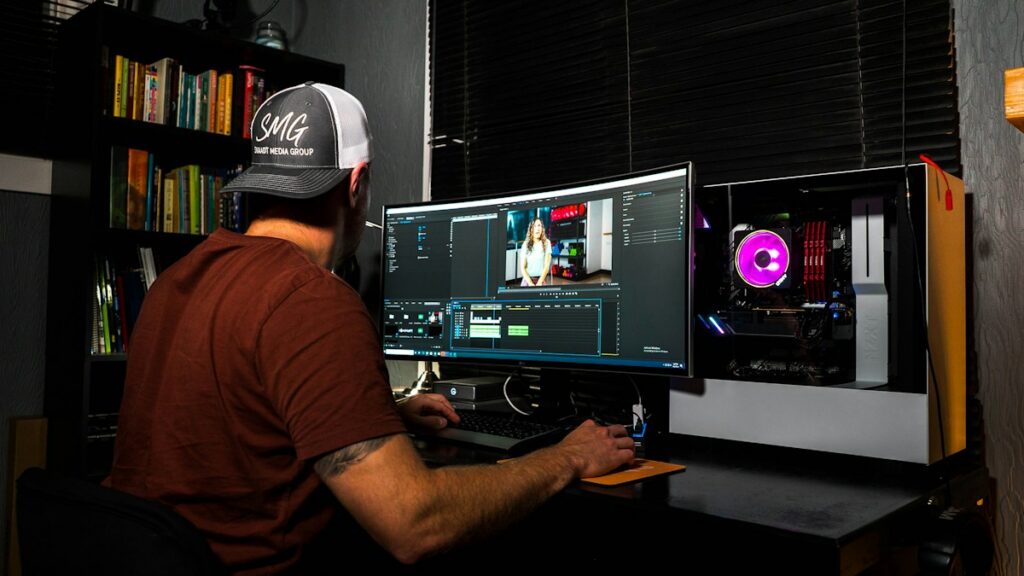 Video creator editing a YouTube production at a computer
