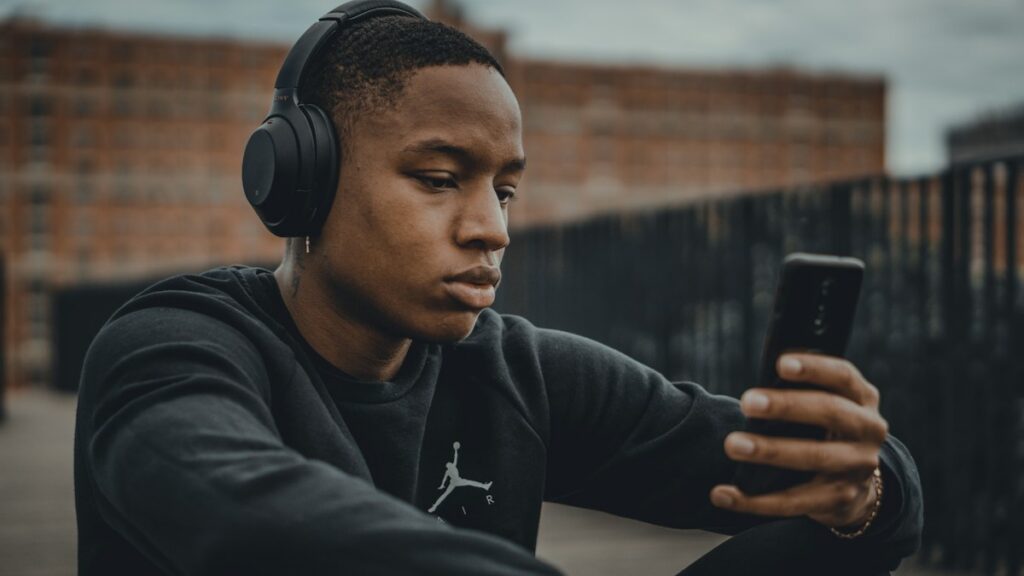 Man listening with headphones in an editorial image about hearing support claims