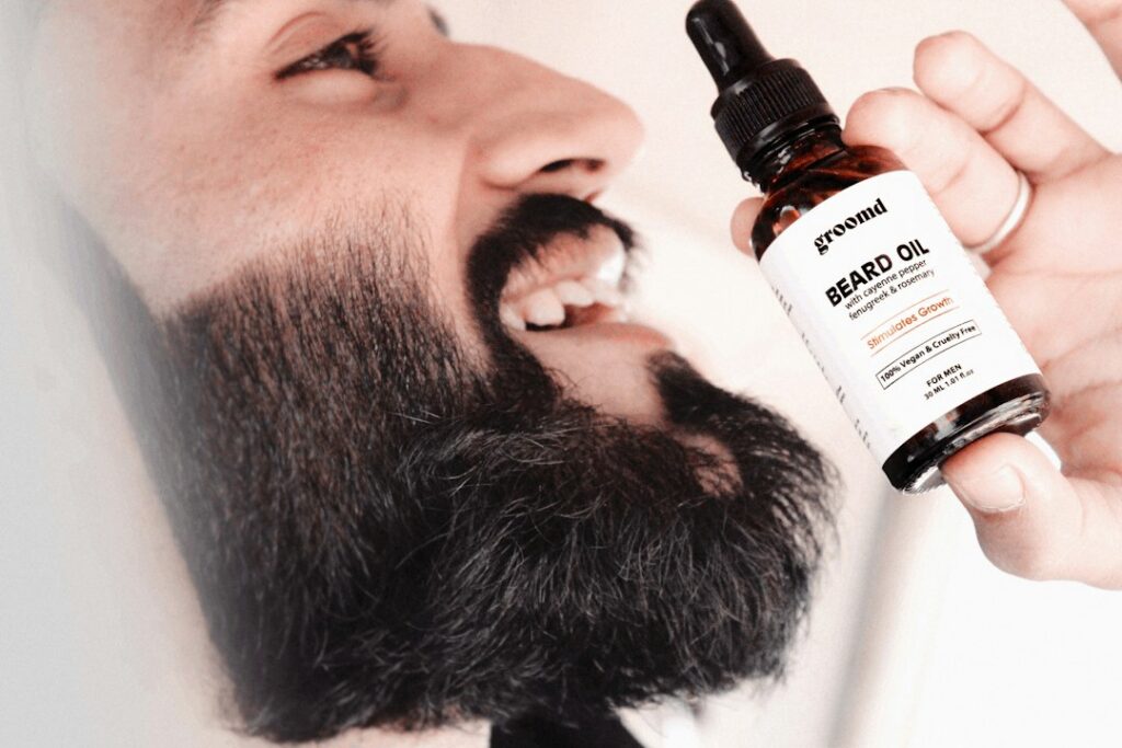 Beard oil and beard balm arranged beside grooming tools