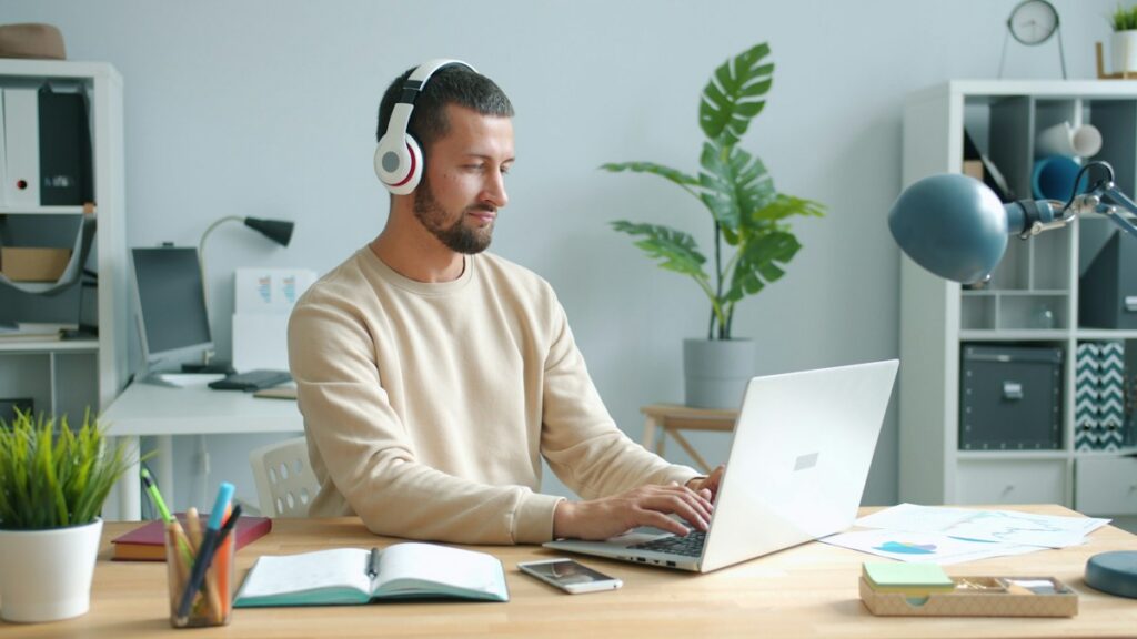 Man wearing headphones while working at a desk