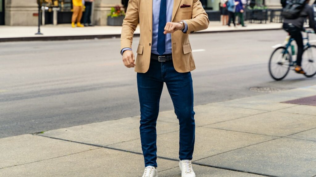 Man in a blazer and casual trousers in a city setting