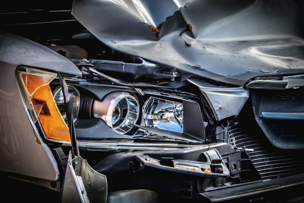Damaged vehicle being inspected at a repair shop