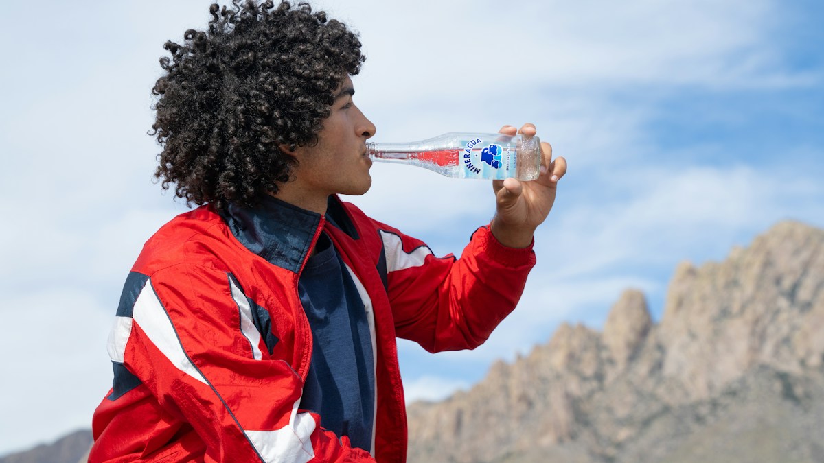 Man drinking water during an active day.