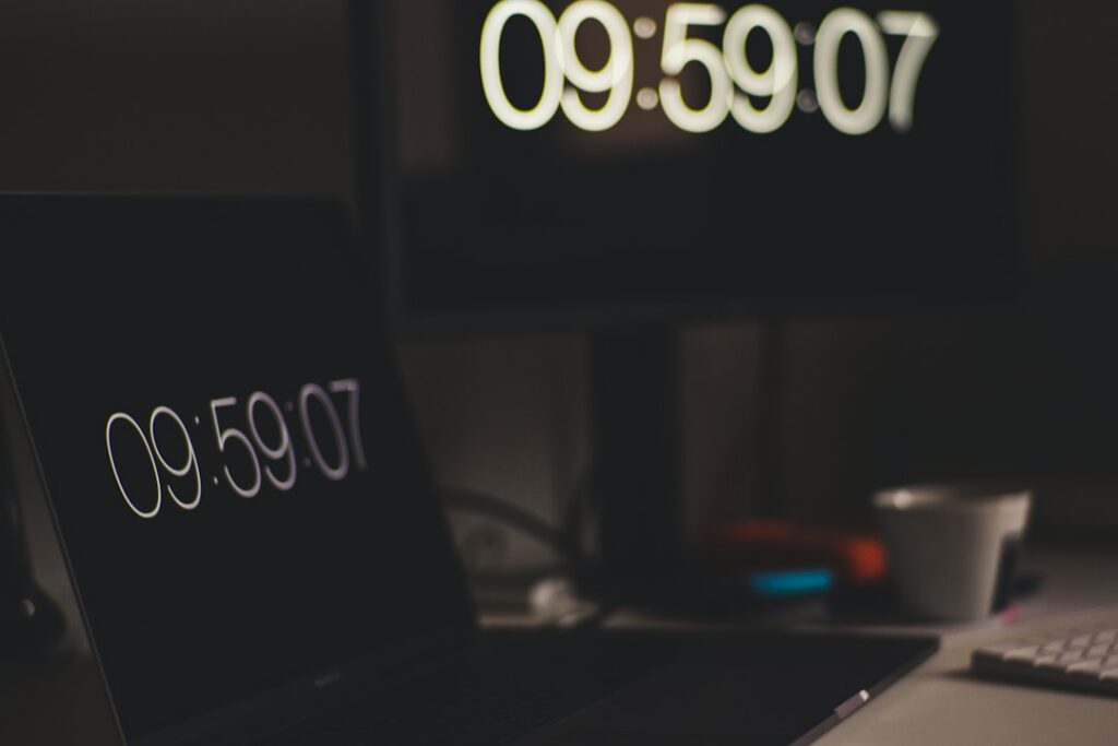 Focused work desk with timer notebook and laptop