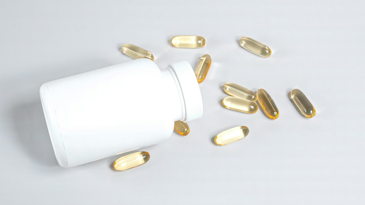 Dietary supplement capsules and bottle used as an editorial image for a supplement buyer review