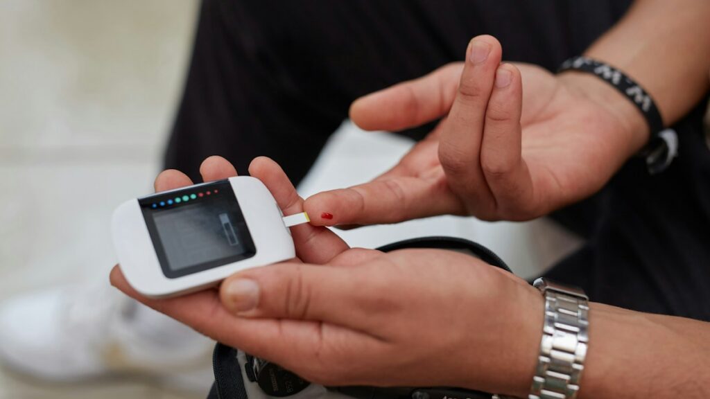 Man checking blood glucose with a glucose meter