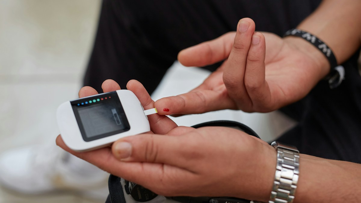 Man checking blood glucose with a glucose meter