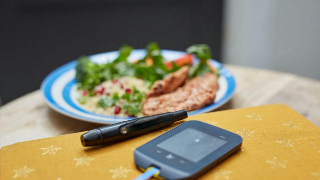 Blood glucose meter beside a meal in an editorial supplement review