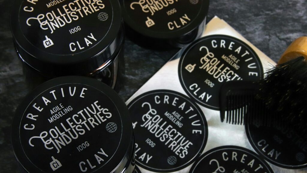 Hair styling product tins on a dark background