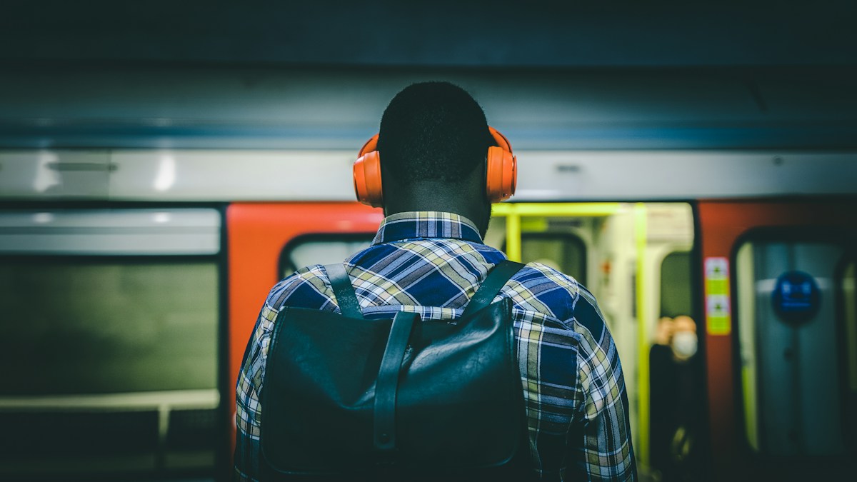 Commuter wearing headphones on public transport