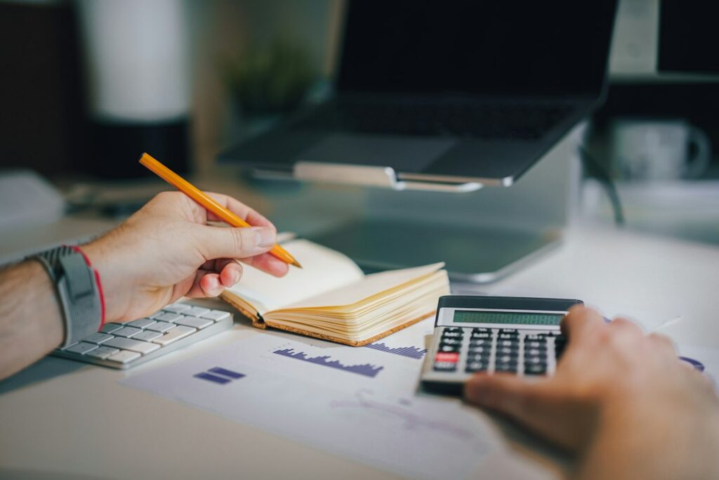Personal budget and savings planning with calculator and notebook