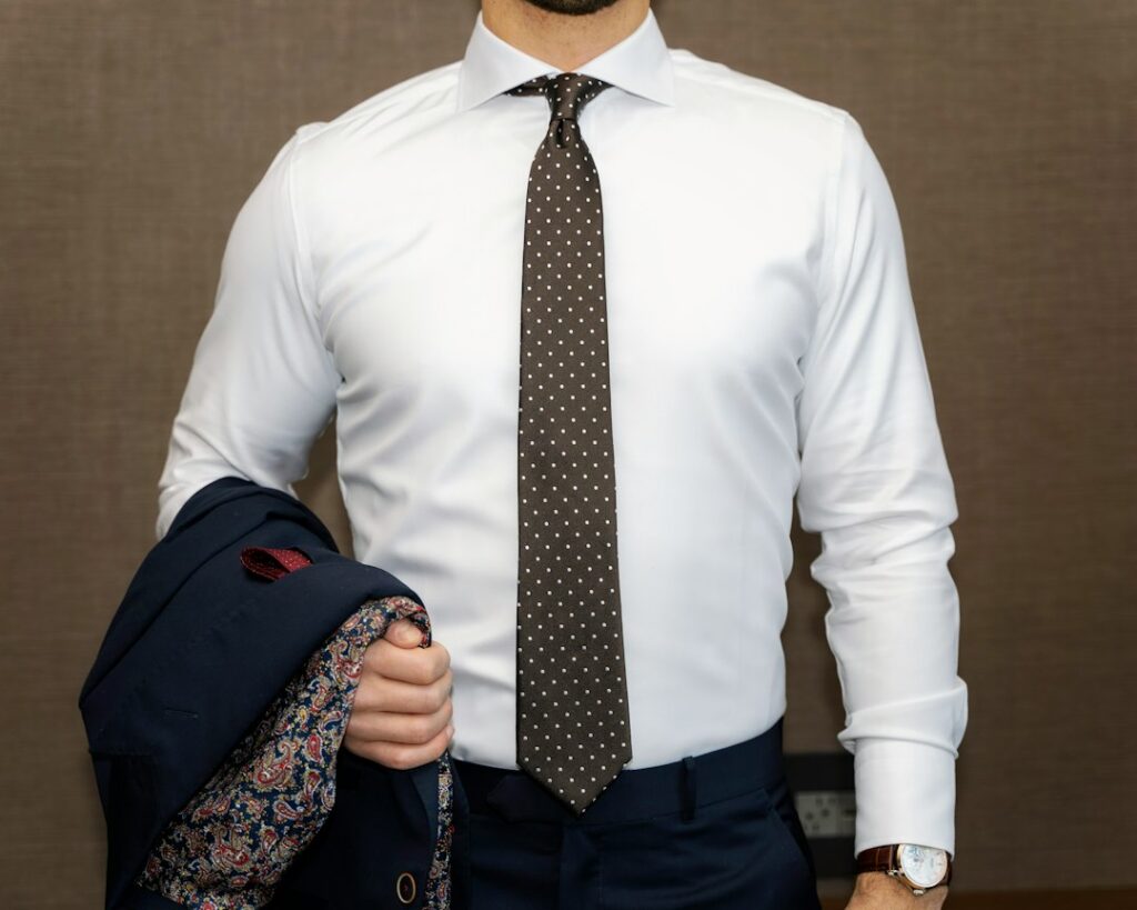 Man checking collar sleeve and torso fit of a dress shirt