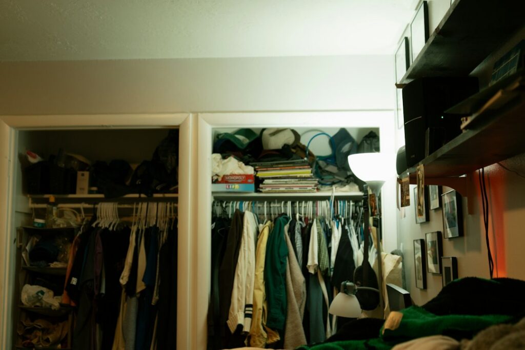 Man organizing an existing wardrobe to dress better without buying more