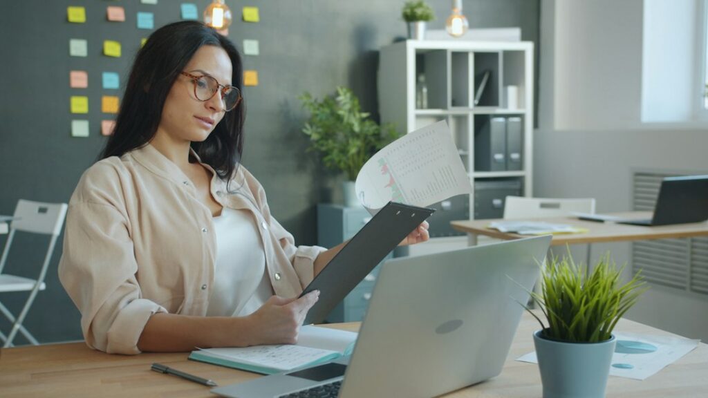 Professional preparing documents and notes for a performance review