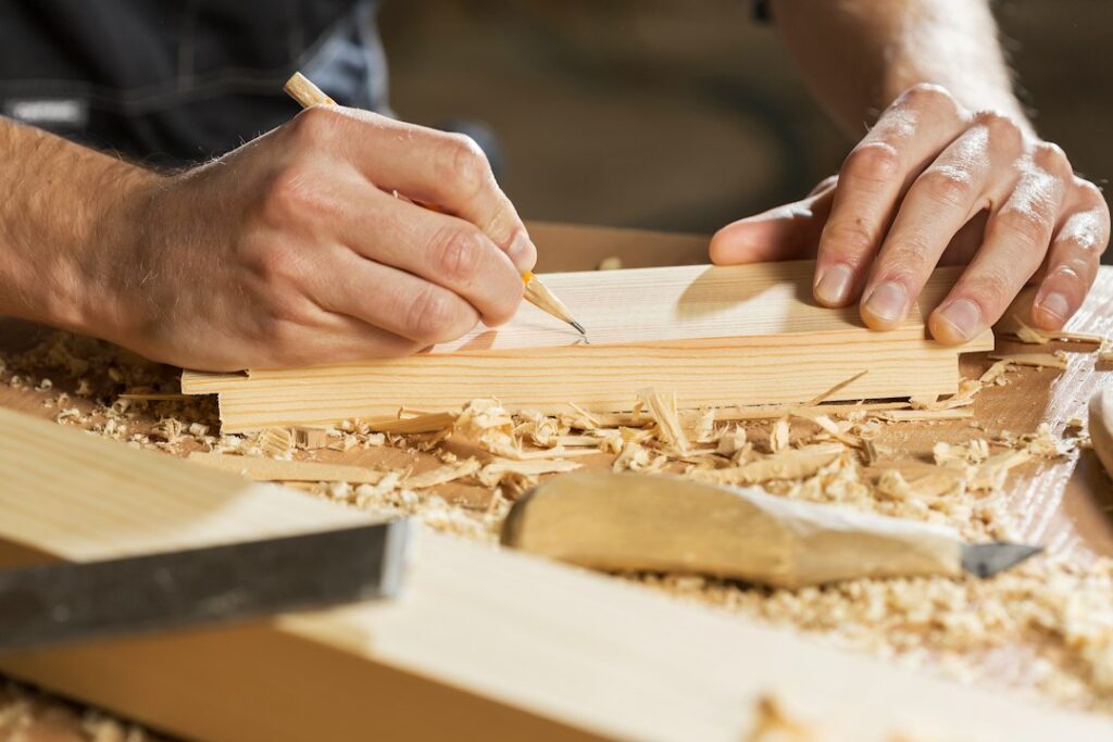 Man woodworking in a compact workshop with hand tools