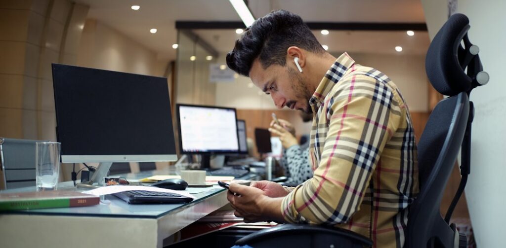 Smartphone placed face down while a man works without distraction