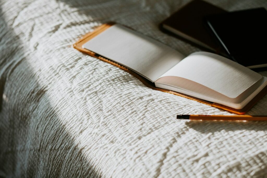 Journal and meditation setup representing two mental discipline practices
