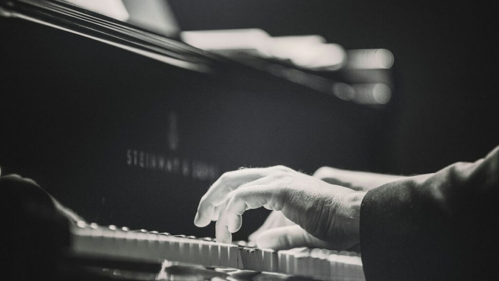 Person playing keys on a piano