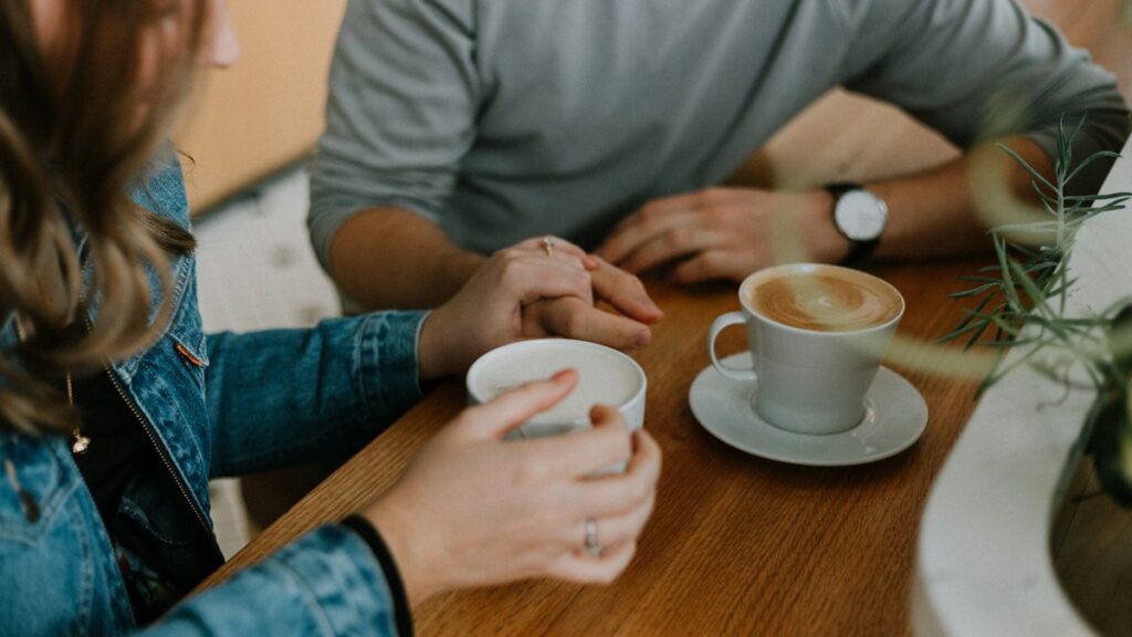 Two coffee mugs on a table during a casual date