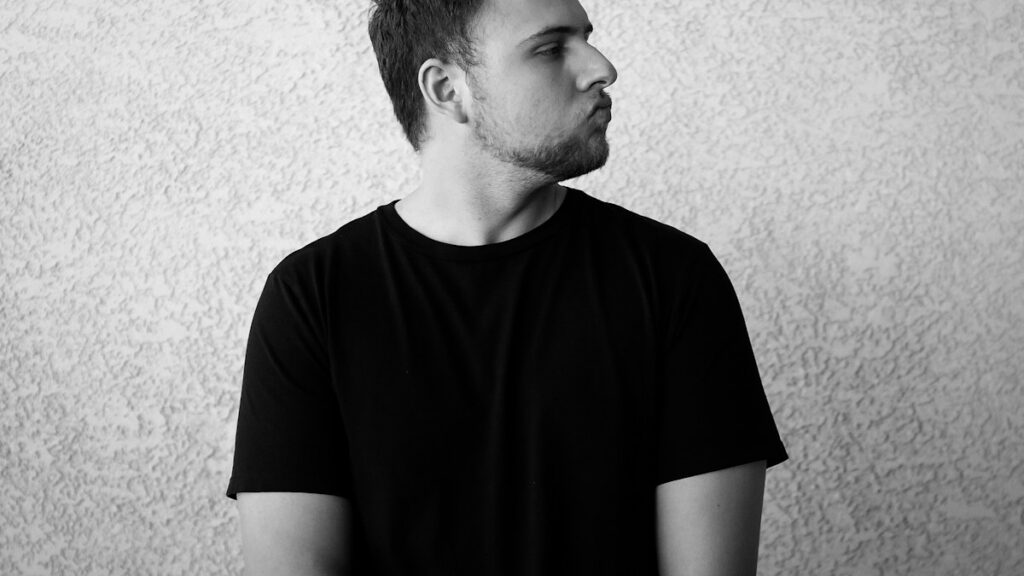 Man wearing a dark crewneck T-shirt