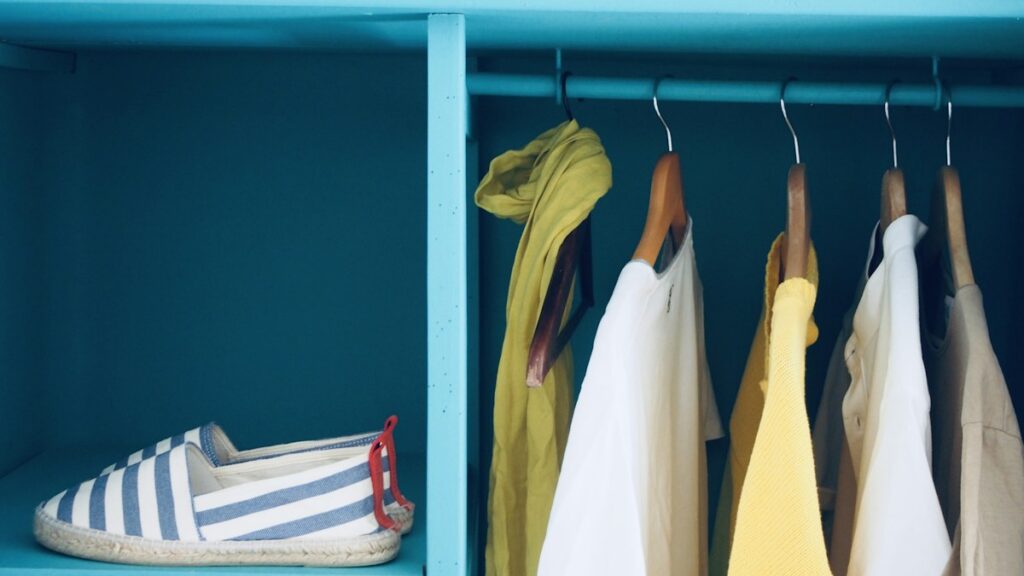 Clothing organized in a closet for a capsule wardrobe guide