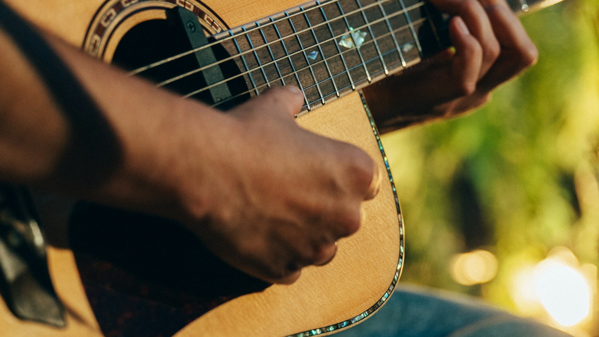 Guitarist practicing on an acoustic guitar