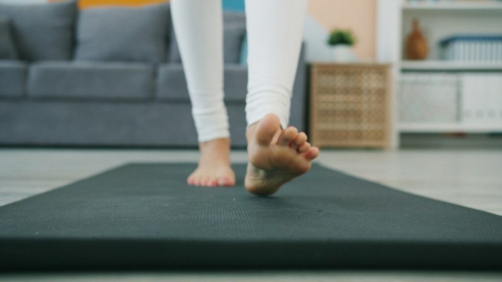 Man holding his foot while dealing with nerve discomfort