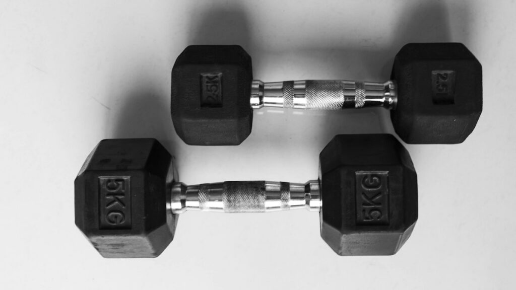Dumbbells on a gym floor for an editorial review of a fitness supplement