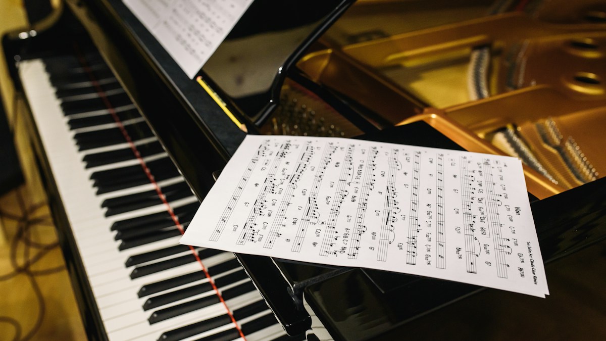 Sheet music resting above piano keys during practice
