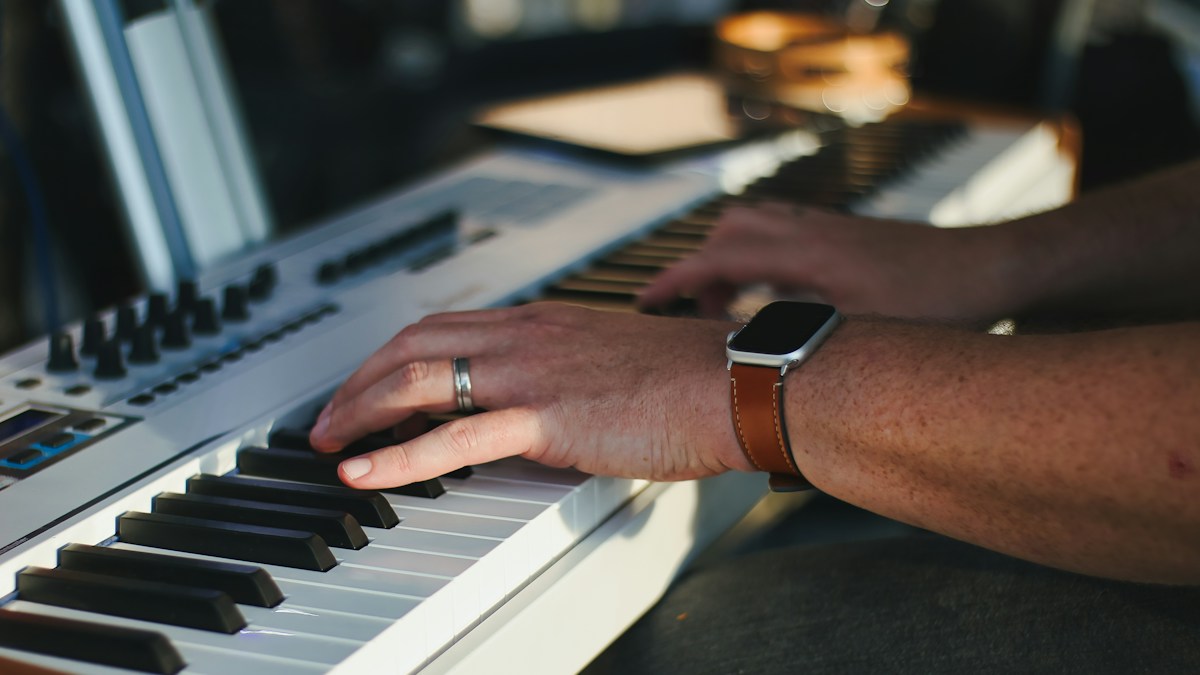 Hands practicing piano technique on a keyboard