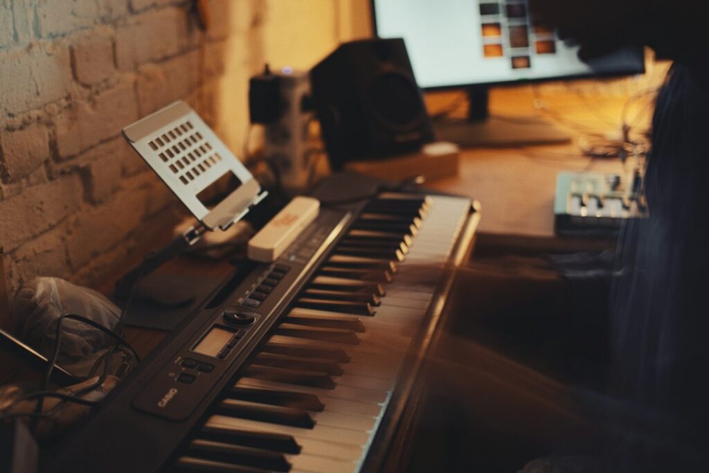Adult man learning to play piano at home