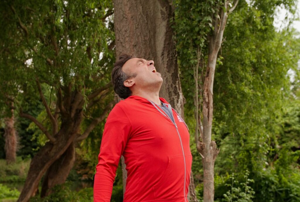 Man doing a calm breathing exercise outdoors