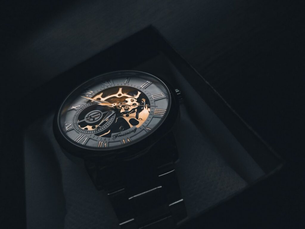 Two wristwatches representing automatic and quartz movements
