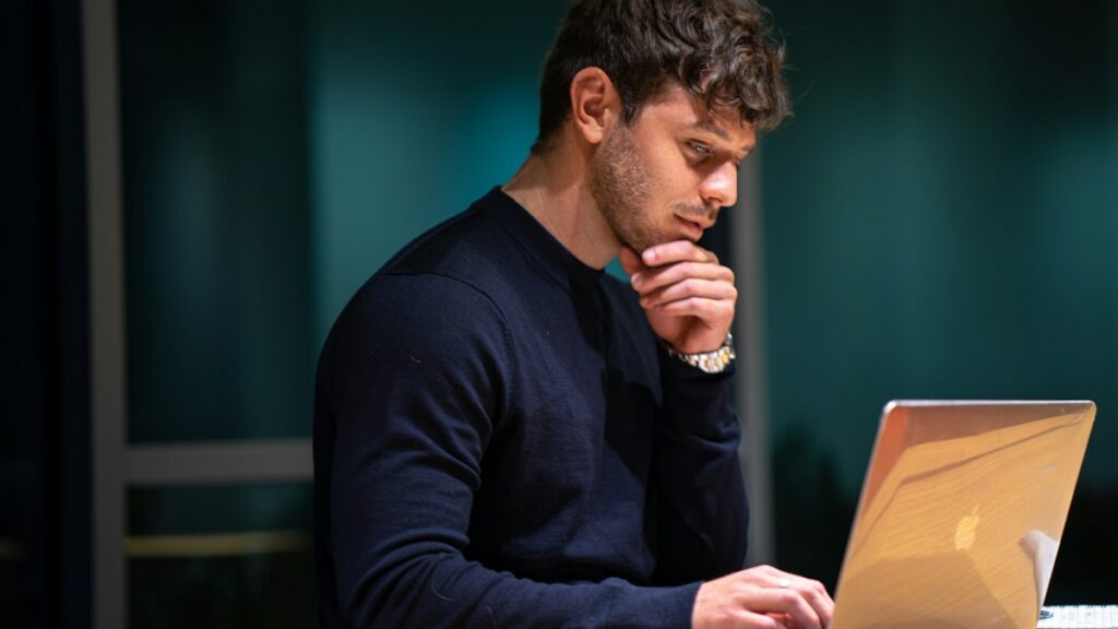 Man working at a laptop with focused attention