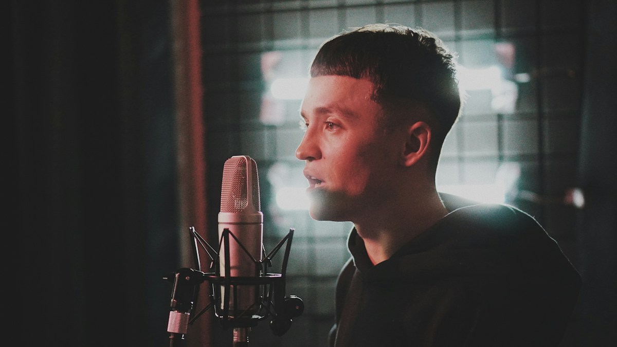 Man practicing singing with a microphone
