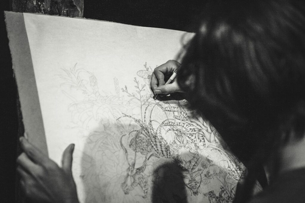 Artist drawing a portrait on paper for a Soulmate Sketch review