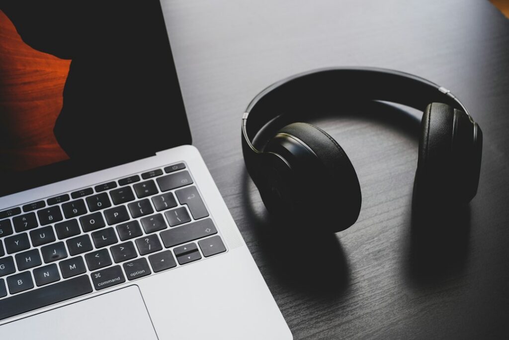 Home voiceover production setup with laptop microphone and headphones