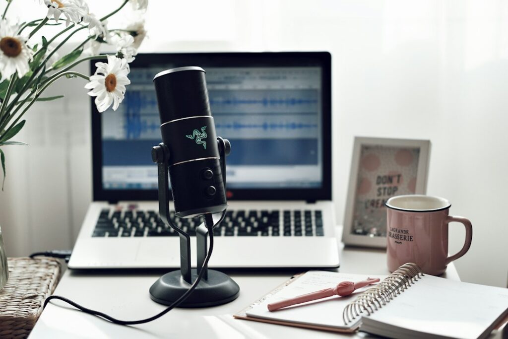 Voice recording studio setup beside a laptop for AI voice comparison
