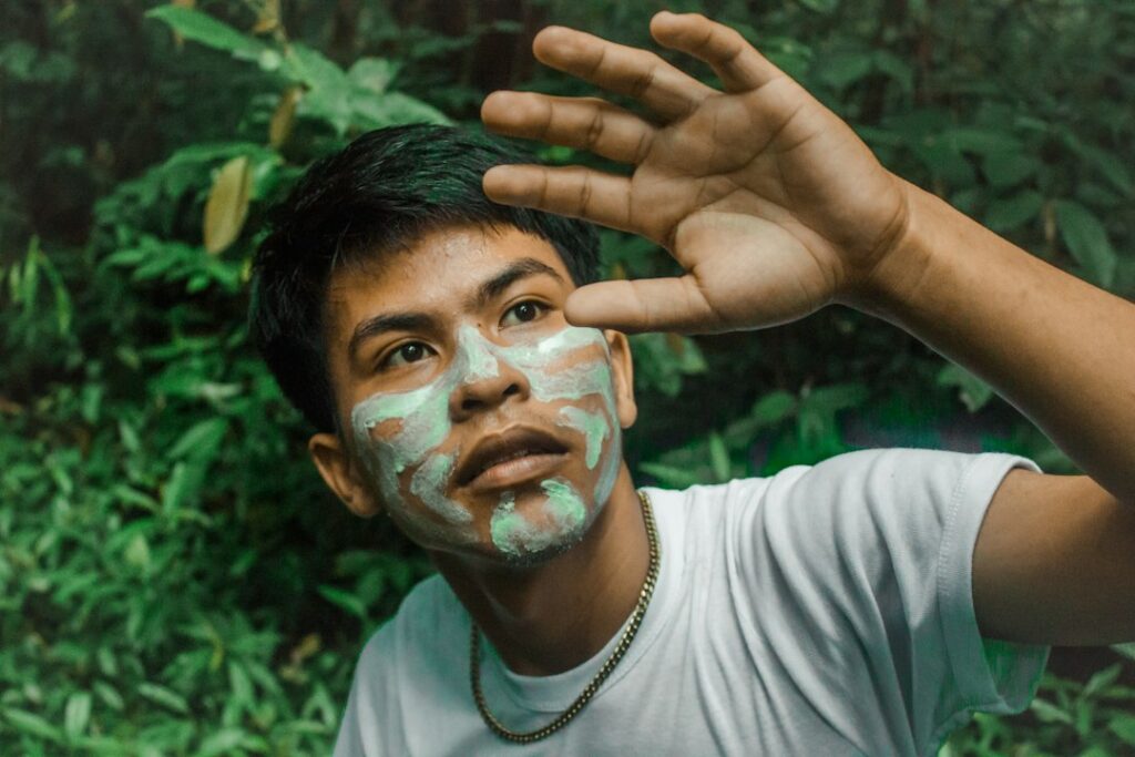 Man applying sunscreen to his face before going outdoors