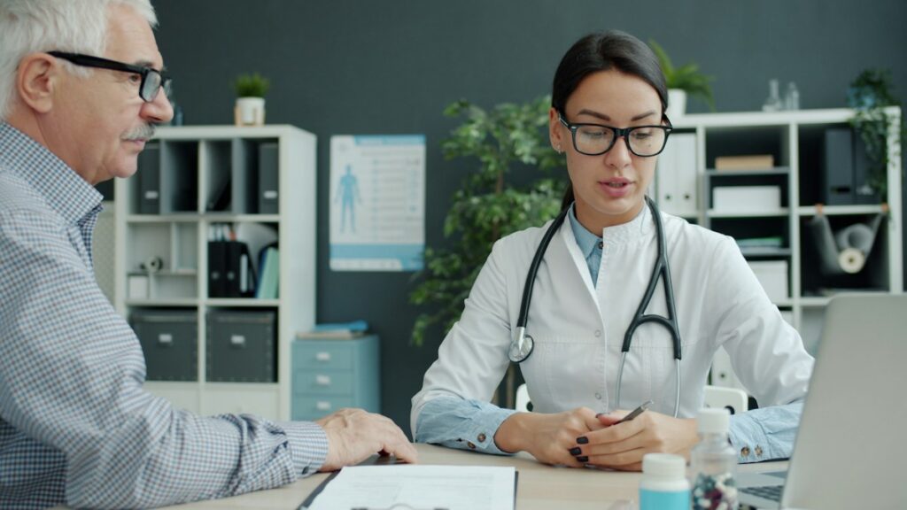 Older man discussing health with a clinician