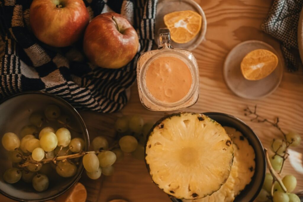 Fresh smoothie with fruit and blender in a home kitchen