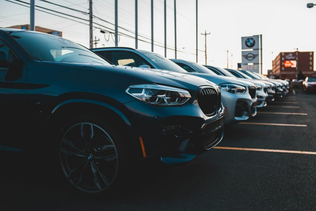 Used car buyer speaking with a seller at a car lot