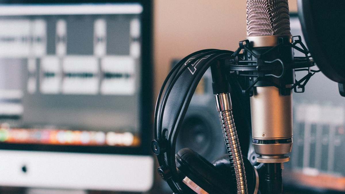 Microphone and headphones in a home voiceover recording workspace