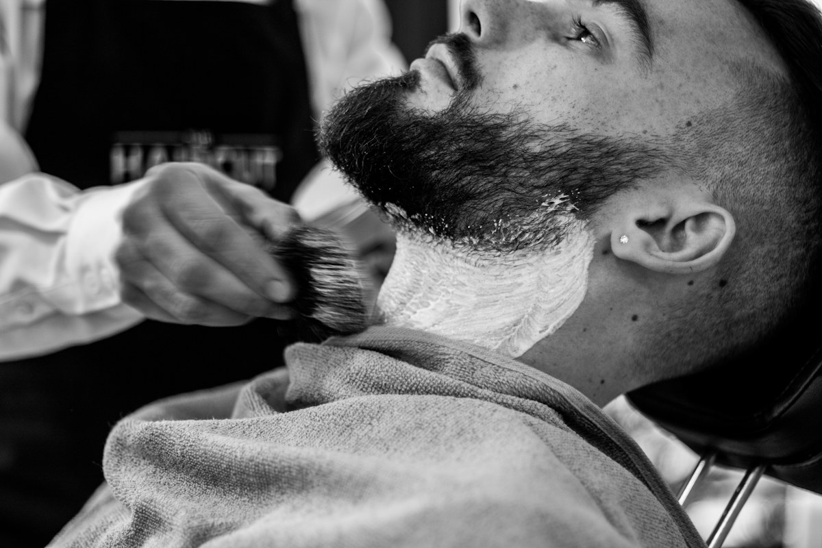 Man carefully trimming and shaving his beard