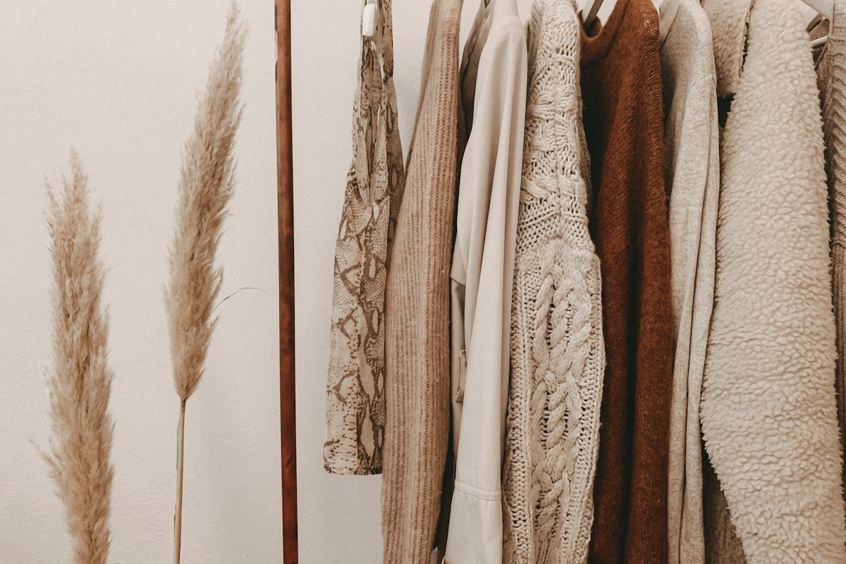 Neutral clothing arranged on a compact wardrobe rack