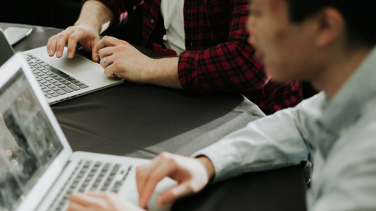 Coworkers reviewing work together at a laptop