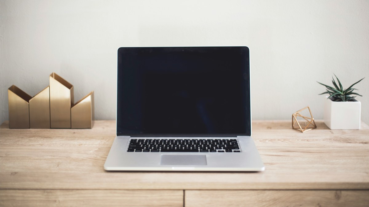 Open laptop on a clear wooden desk