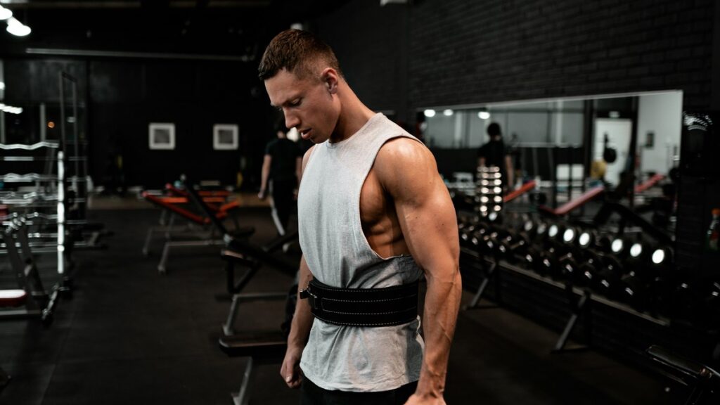 Man standing with training straps in a gym