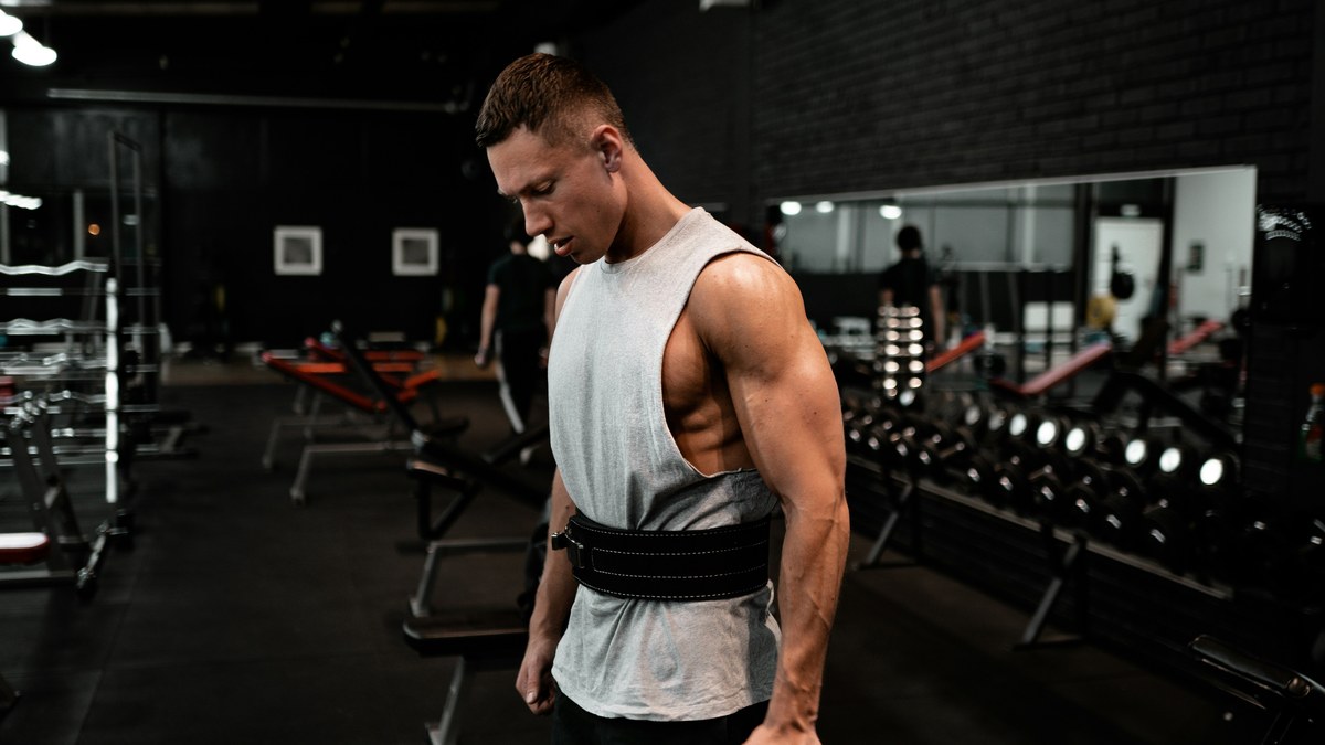 Man standing with training straps in a gym